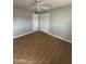 Bedroom with ceiling fan, closet and wood-look laminate flooring at 1172 E Delano Dr, Casa Grande, AZ 85122