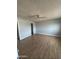 Neutral bedroom with ceiling fan and wood-look laminate flooring at 1172 E Delano Dr, Casa Grande, AZ 85122