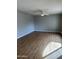 Empty bedroom with neutral walls, ceiling fan, and wood-look laminate flooring at 1172 E Delano Dr, Casa Grande, AZ 85122