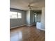 Sunlit bedroom with laminate wood flooring features a window and a closet at 1172 E Delano Dr, Casa Grande, AZ 85122