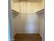 Walk-in closet with rod and shelf, and wood-look laminate flooring at 1172 E Delano Dr, Casa Grande, AZ 85122