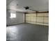 Spacious garage with sealed concrete floors, bright window, and storage cabinets at 1172 E Delano Dr, Casa Grande, AZ 85122