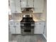 Stainless steel double oven range with custom white cabinets and countertops at 1172 E Delano Dr, Casa Grande, AZ 85122