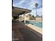 Backyard pool and spa area with a tanning ledge and an umbrella for shade and relaxation at 1172 E Delano Dr, Casa Grande, AZ 85122