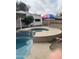 In-ground pool with tiled jacuzzi and an outdoor fire pit area for year-round relaxation and entertaining at 1172 E Delano Dr, Casa Grande, AZ 85122