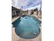 Outdoor in-ground swimming pool with a colorful sun umbrella and adjacent jacuzzi for backyard enjoyment at 1172 E Delano Dr, Casa Grande, AZ 85122