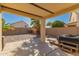 Back covered patio with a backyard view of desert landscaping, block wall, and clear sky at 14787 W Aster Dr, Surprise, AZ 85379