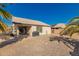 View of the backyard patio and desert landscaping with block wall and a clear blue sky at 14787 W Aster Dr, Surprise, AZ 85379