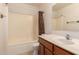 Clean, bright bathroom with vanity, mirror, toilet, and bathtub with shower curtain at 14787 W Aster Dr, Surprise, AZ 85379