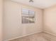 Well-lit bedroom with window overlooking greenery, and carpeted floor at 14787 W Aster Dr, Surprise, AZ 85379