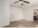 Spacious bedroom with a view of the ensuite bathroom and a ceiling fan at 14787 W Aster Dr, Surprise, AZ 85379