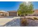 Charming single-story home with mature landscaping, brown garage door, and tile roof at 14787 W Aster Dr, Surprise, AZ 85379