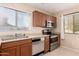 Kitchen with stainless steel appliances, laminate countertops, and wood cabinets at 14787 W Aster Dr, Surprise, AZ 85379