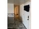 Hallway featuring marble tile flooring, storage options, and a view of the back of the home at 155 W Hunter St, Mesa, AZ 85201