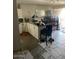 Kitchen with white cabinets and new tile floors being installed next to dining area at 155 W Hunter St, Mesa, AZ 85201