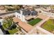 Aerial view shows the 2-story home, dark roof, fenced yard, covered patio, and nearby neighborhood at 15619 N 30Th Ave, Phoenix, AZ 85053