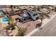 Wide aerial view of the property showing the backyard with a pool, patio, and xeriscaped yard at 15619 N 30Th Ave, Phoenix, AZ 85053