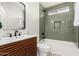 Stylish bathroom featuring a modern vanity and tub with subway tile surround at 15619 N 30Th Ave, Phoenix, AZ 85053