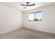 Bright bedroom featuring a ceiling fan and a window providing natural light at 15619 N 30Th Ave, Phoenix, AZ 85053