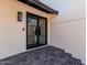 Stylish front entrance with a black framed glass door and decorative outdoor lighting at 15619 N 30Th Ave, Phoenix, AZ 85053