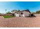 Charming two-story home shows neutral exterior, dark roof, and gravel yard with small patch of turf at 15619 N 30Th Ave, Phoenix, AZ 85053