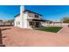 Two-story home with dark roof, small square of artificial turf, covered patio, and gravel yard at 15619 N 30Th Ave, Phoenix, AZ 85053