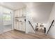 Hallway and staircase featuring a built-in storage console and wood-look flooring at 15619 N 30Th Ave, Phoenix, AZ 85053