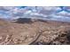 High aerial view of residential homes, mountain and desert landscape, roads, and blue skies at 16060 S 4Th St, Phoenix, AZ 85048