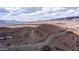 Beautiful aerial view of desert landscape and home, with hiking trail under a partly cloudy sky at 16060 S 4Th St, Phoenix, AZ 85048