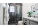 Updated bathroom with glass shower door, tiled shower and grey vanity at 16060 S 4Th St, Phoenix, AZ 85048