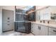 Bathroom featuring gray cabinets, white countertops, and luxurious glass-enclosed shower at 16060 S 4Th St, Phoenix, AZ 85048