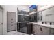 Luxurious bathroom featuring gray cabinets, white countertops, and glass-enclosed shower at 16060 S 4Th St, Phoenix, AZ 85048