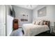 Cozy bedroom featuring a comfortable bed, a vintage radio cabinet and soothing gray walls at 16060 S 4Th St, Phoenix, AZ 85048