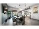 Open-concept dining room with tile floors, modern lighting, and sliding doors to the patio at 16060 S 4Th St, Phoenix, AZ 85048