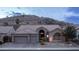 Charming home with a two-car garage, desert landscaping, and a mountain backdrop at 16060 S 4Th St, Phoenix, AZ 85048