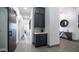 Hallway featuring gray tile flooring, a dark wood sliding door, and a beverage station with white countertops at 16060 S 4Th St, Phoenix, AZ 85048