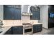 Close up of modern kitchen with stainless steel oven and vent hood at 16060 S 4Th St, Phoenix, AZ 85048