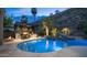 Backyard pool and seating area with outdoor kitchen and desert landscaping at 16060 S 4Th St, Phoenix, AZ 85048