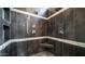 Luxurious, glass-enclosed shower featuring dual shower heads and built-in corner seat at 16060 S 4Th St, Phoenix, AZ 85048