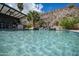 Backyard swimming pool with a rock waterfall feature and crystal clear water at 16060 S 4Th St, Phoenix, AZ 85048