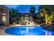 Lush backyard with inviting pool, rock waterfall, and outdoor kitchen area for relaxing and entertaining at 16060 S 4Th St, Phoenix, AZ 85048