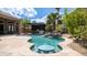 Backyard pool with a waterfall, outdoor kitchen, and built-in seating, perfect for entertaining at 16060 S 4Th St, Phoenix, AZ 85048