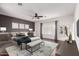 Spacious main bedroom with a large bed, bench, stylish rug, and ample natural light from multiple windows at 16549 W Rowel Rd, Surprise, AZ 85387