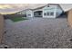 Backyard of home with green turf and decorative rock at 17019 W Cameron Dr, Surprise, AZ 85388