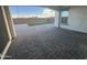 Covered patio with view of the backyard with turf, pavers and rock at 17019 W Cameron Dr, Surprise, AZ 85388