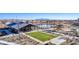 An aerial view of the community pool area featuring ample seating, grassy area, and shaded structures at 17019 W Cameron Dr, Surprise, AZ 85388