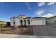 Charming single-story home with an attached two-car garage and beautifully landscaped front yard at 17019 W Cameron Dr, Surprise, AZ 85388