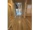 A bright and airy hallway features new light-colored floors that run the length of the house at 17019 W Cameron Dr, Surprise, AZ 85388