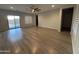 A bright and spacious living room features new light-colored floors and a ceiling fan at 17019 W Cameron Dr, Surprise, AZ 85388