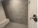 Detailed shot of walk-in shower showcasing neutral tile and built-in bench at 17019 W Cameron Dr, Surprise, AZ 85388